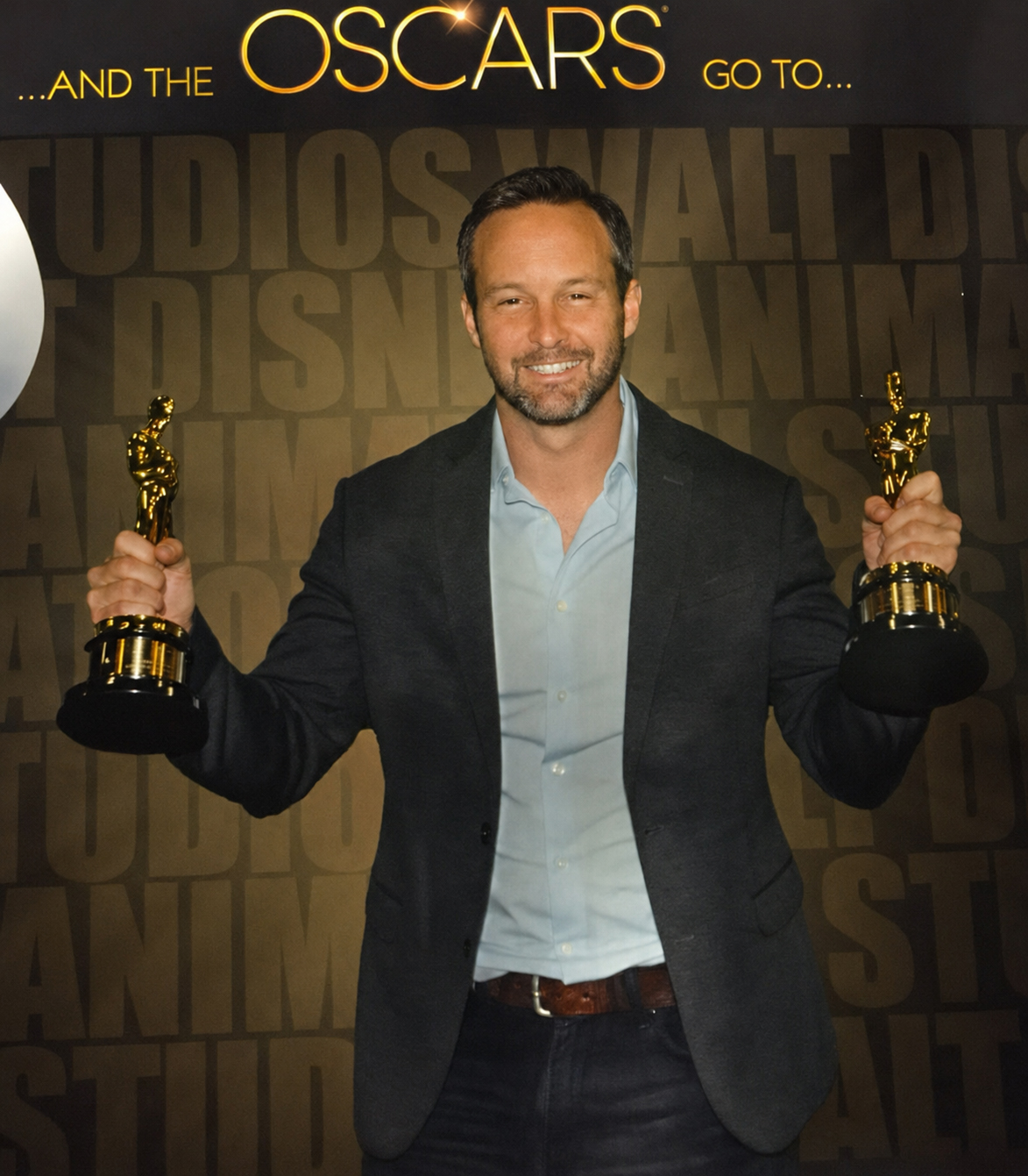 David Kersey holding two Academy Awards at the Walt Disney Animation Studios Oscars